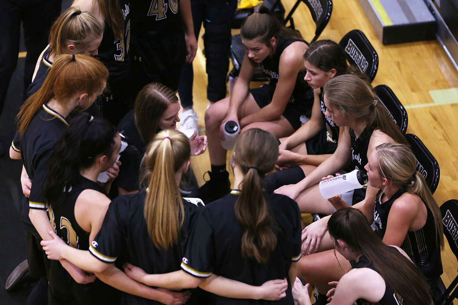 Buffalo’s varsity girls basketball team huddles together during a time out